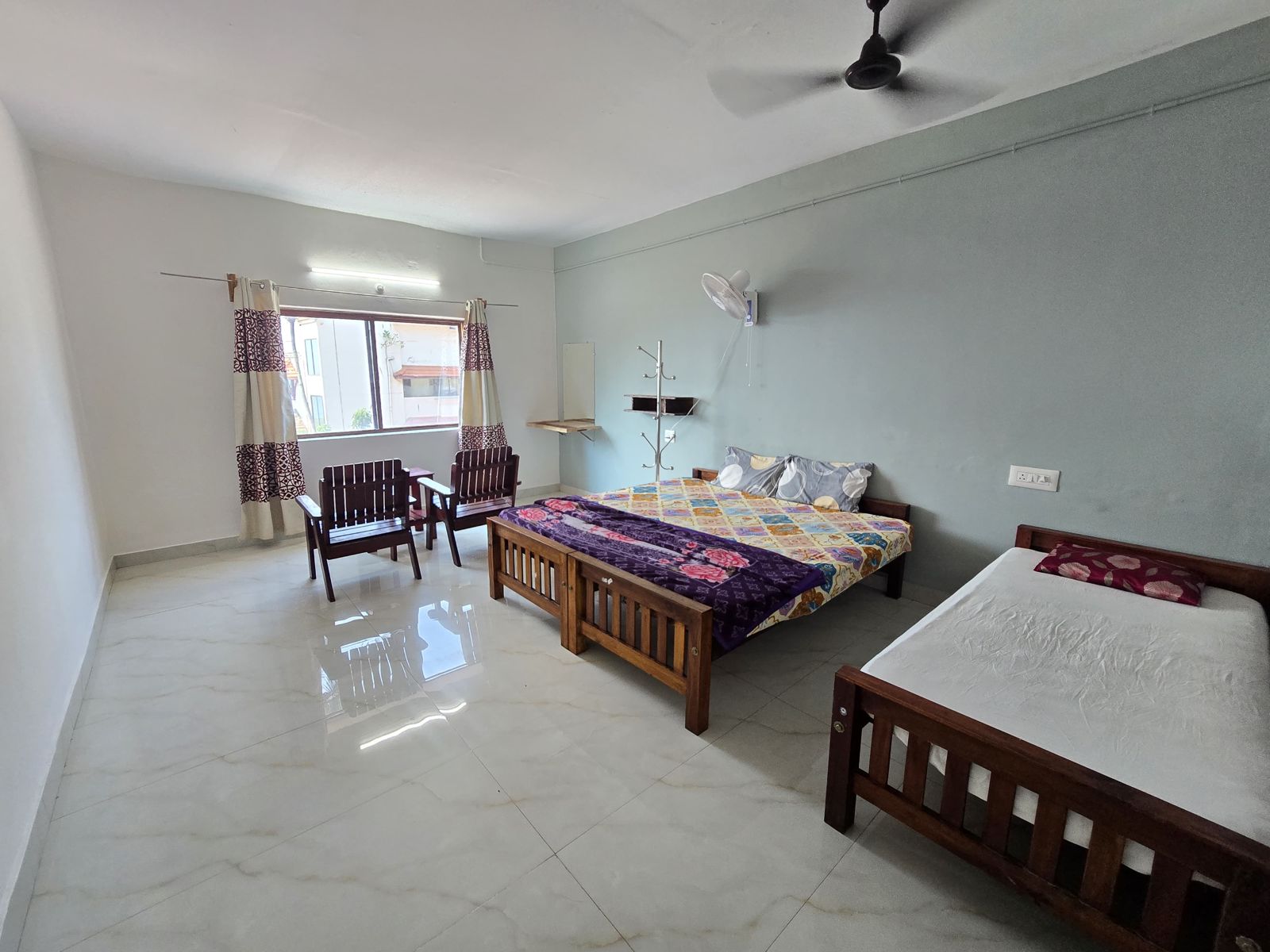 Room with a double bed and a single bed